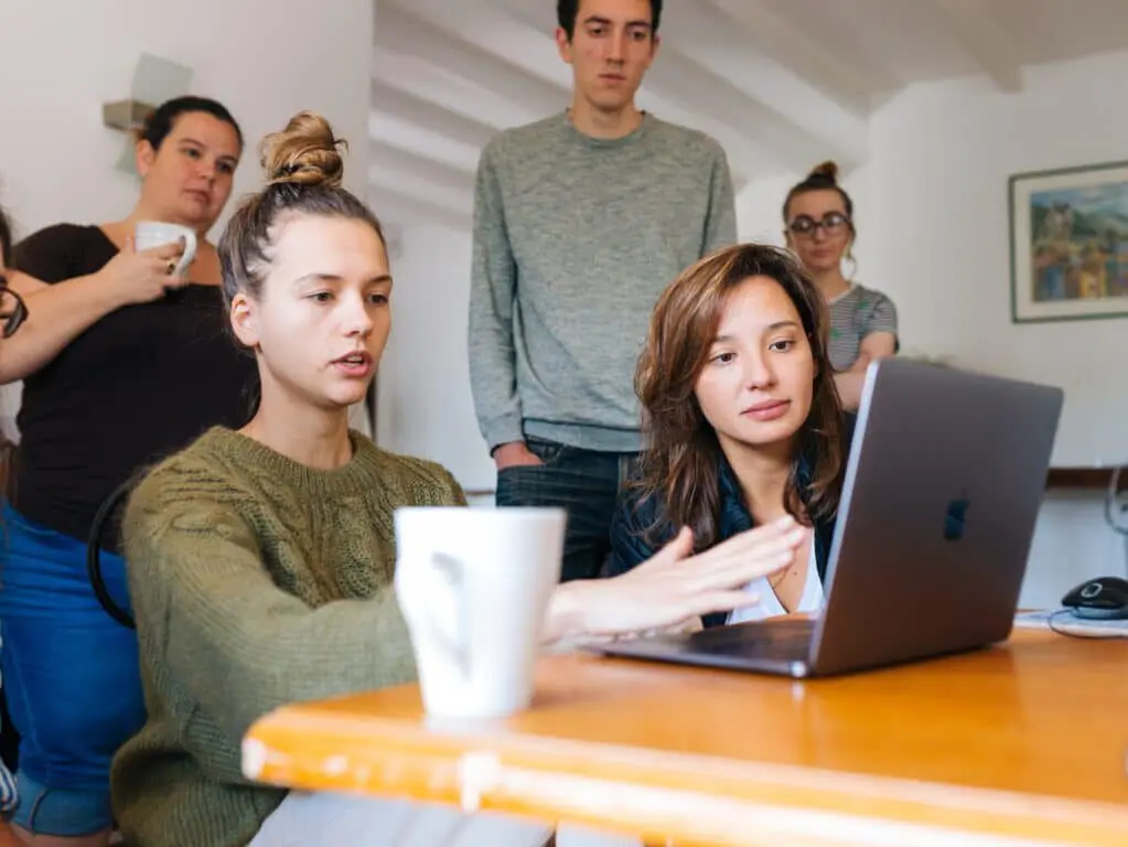 Team looks at a laptop